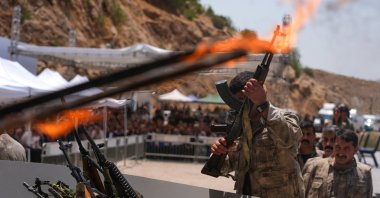 A PKK terrorist puts his weapon into a pit during the disarmament ceremony in the city of Sulaymaniyah, Iraq, July 11, 2025. (AA File Photo)