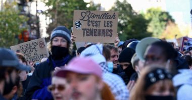 Demonstrators show a placard that reads: "Bismillah, it's the darkness" during a a students' protest in Brussels, Belgium, Oct. 17, 2026. (Reuters Photo)