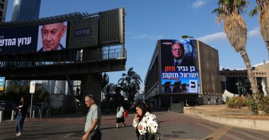 People pass by election billboards featuring an image of Israeli Prime Minister Benjamin Netanyahu (L) and one with an image of Israeli National Security Minister Itamar Ben Gvir reading in Hebrew 'Ben Gvir is strong, Israel is strong!' in Ramat Gan near Tel Aviv, Israel, Oct. 18, 2026. (EPA Photo)