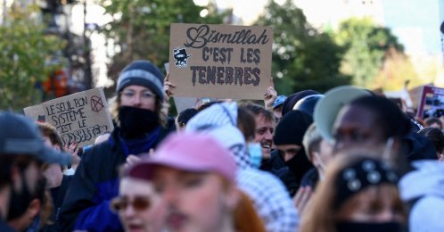 Demonstrators show a placard that reads: "Bismillah, it's the darkness" during a a students' protest in Brussels, Belgium, Oct. 17, 2026. (Reuters Photo)