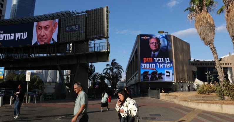 People pass by election billboards featuring an image of Israeli Prime Minister Benjamin Netanyahu (L) and one with an image of Israeli National Security Minister Itamar Ben Gvir reading in Hebrew 'Ben Gvir is strong, Israel is strong!' in Ramat Gan near Tel Aviv, Israel, Oct. 18, 2026. (EPA Photo)