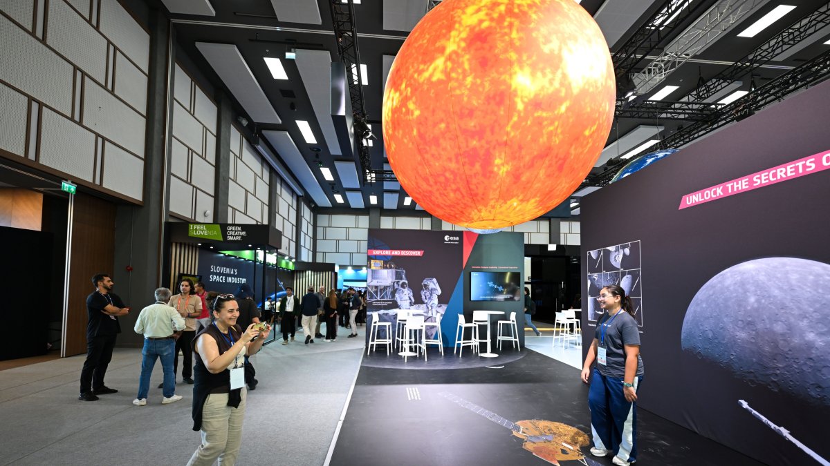 People take photos at the venue of the 77th International Astronautical Congress (IAC) held in Antalya, southern Türkiye, Oct. 9, 2026. (AA Photo)