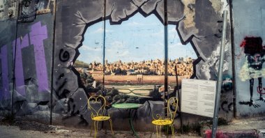 Colorful political graffiti, murals and messages of resistance cover the massive concrete slabs of the Israeli separation wall, West Bank, occupied Palestine, March 23, 2026. (Shutterstock Photo)