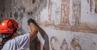 In this undated handout photo provided by the Pompeii Archaeological Park, restorers work inside the House of Marcus Fabius Rufus in Pompeii, near Naples, Italy. (AP Photo)
