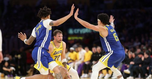 Golden State Warriors' Yaxel Lendeborg (L) and Gui Santos (R) defend against Los Angeles Lakers' Luka Doncic during the first half at Crypto.com Arena, Los Angeles, U.S., Oct. 21, 2026. (AFP Photo)