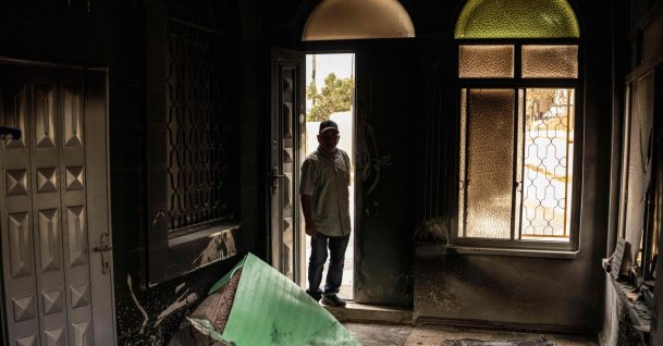 A Palestinian man assesses the damage at a mosque following an arson attack by Israeli terrorist settlers in Mikhmas, in the Israeli-occupied West Bank, Oct. 14, 2026. (AFP Photo)