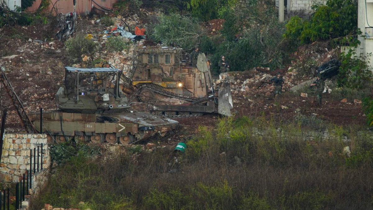 Israeli soldiers, backed by a tank and a bulldozer, conduct search operations among houses in the nearby village of Zawtar al-Sharkiya, as seen from Zawtar al-Gharbiya, southern Lebanon, Oct. 17, 2026. (AFP Photo)