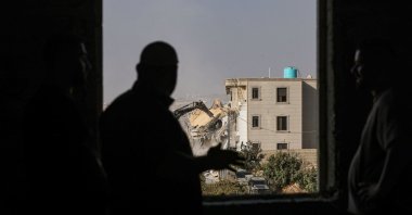 Israeli bulldozers demolish a Palestinian building in Palestinian territory occupied by Israel in the West Bank city of Hebron, Oct. 23, 2026. (AFP Photo)