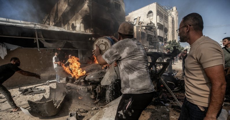 Palestinians attempt to extinguish a fire in a vehicle destroyed in an Israeli airstrike south of Gaza City, Palestine, Oct. 22, 2026. (EPA Photo)