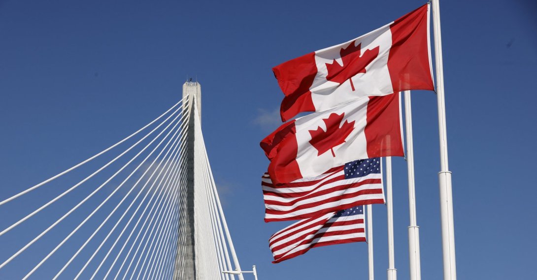 Flags of Canada and the U.S. fly across the international border on the Gordie Howe International Bridge that connects Windsor, Ontario, Canada and Detroit, Michigan, Sept. 6, 2026. (AFP Photo)