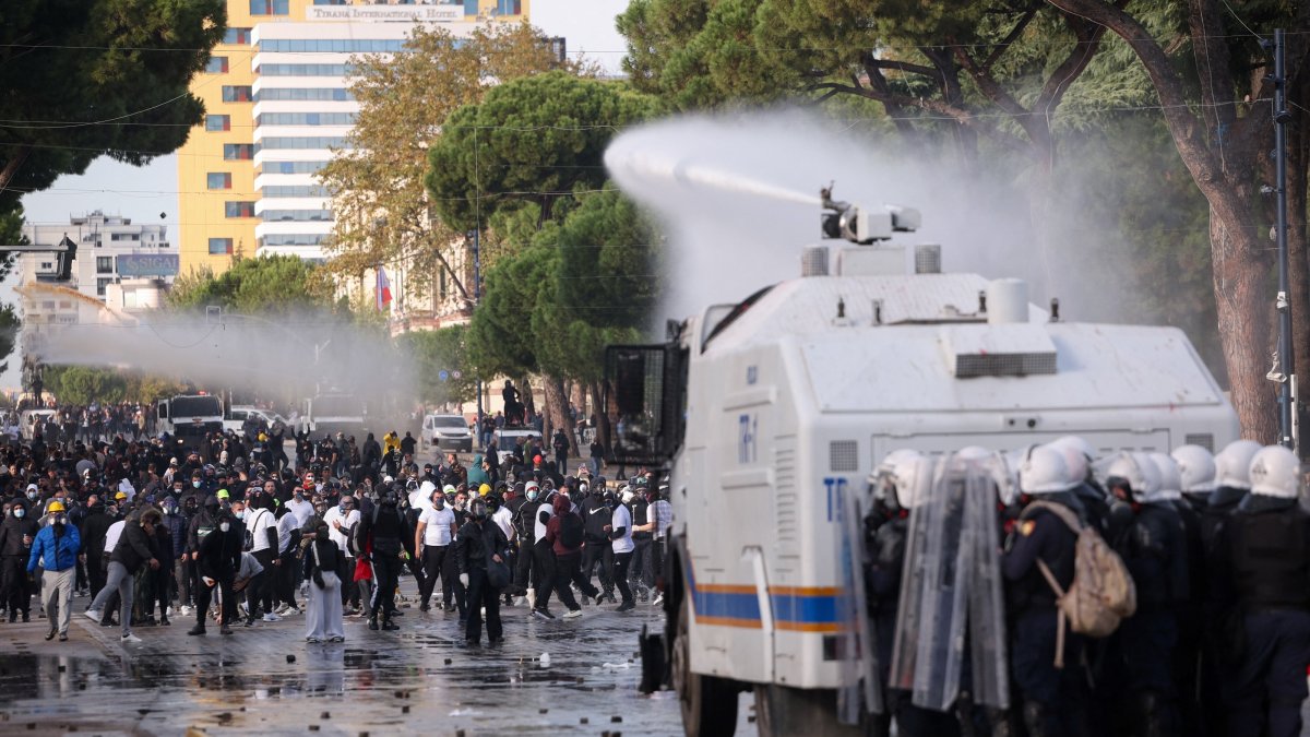 Police in riot gear stand behind an armoured police vehicle as its water cannon sprays water towards demonstrators during an anti-government protest by students, Tirana, Albania, Oct. 24, 2026. (Reuters Photo)