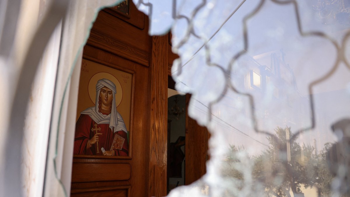 A shattered window at Saint George’s Greek Orthodox Church, where gunmen opened fire during a funeral the previous day, in the village of Hamoud, Karak, Jordan, Oct. 24, 2026. (Reuters Photo)