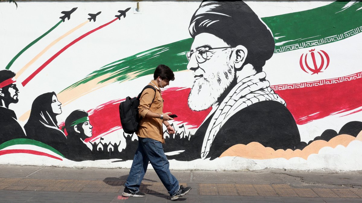 A man walks past a mural of late Iranian Supreme Leader Ayatollah Ali Khamenei on a street in Tehran, Iran, Oct. 14, 2026. (EPA Photo)
