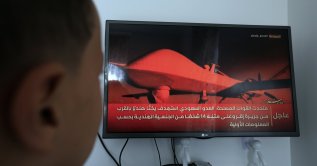 A person follows television coverage of the Saudi-Houthi conflict in Sanaa, Yemen, Oct. 22, 2026. (EPA Photo)