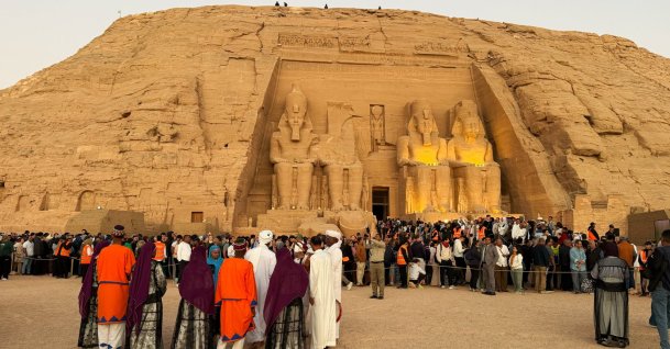 Tourists crowd to watch the sun as it sends a beam of light into the Great Temple of Ramses II's dark inner chamber, Abu Simbel, south of Cairo, Egypt, Oct. 22, 2026. (AP Photo)