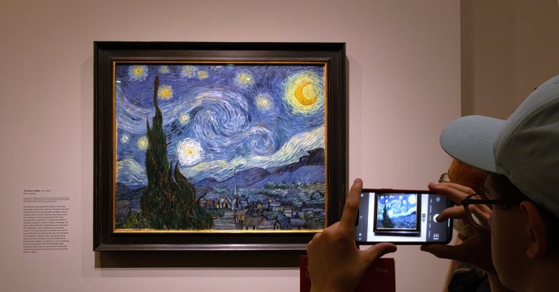 A tourist photographs "The Starry Night" painting by Vincent Van Gogh, New York, U.S., Aug. 22, 2023. (Shutterstock Photo)