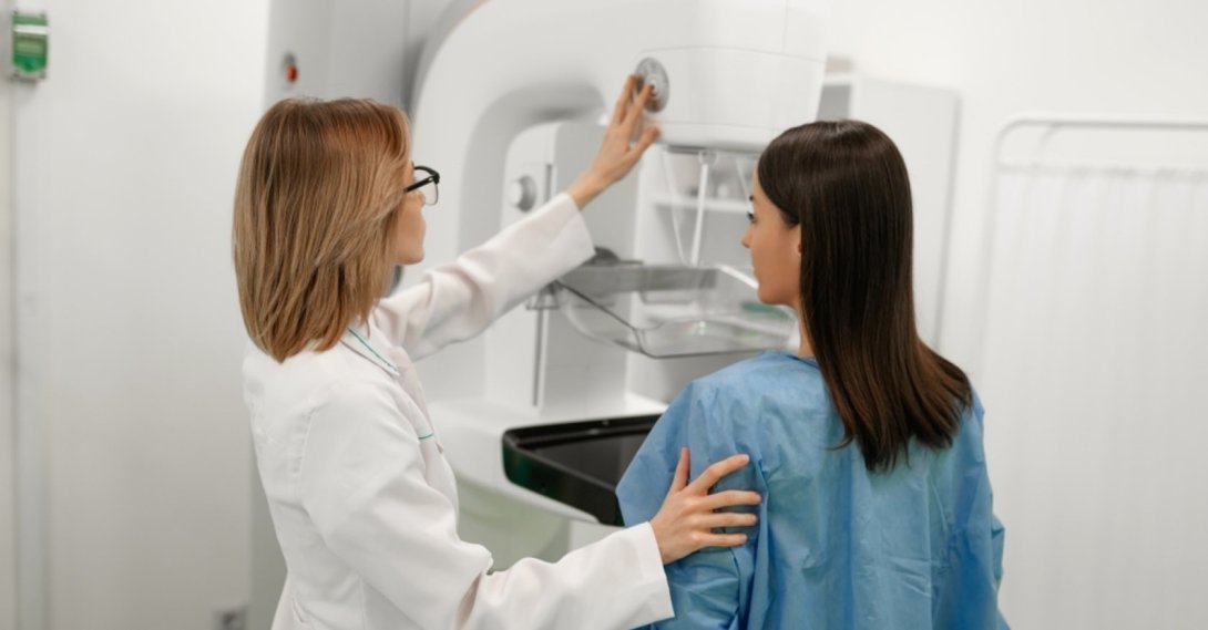 A doctor assists a patient during a mammography screening for early breast cancer detection. (Shutterstock Photo)