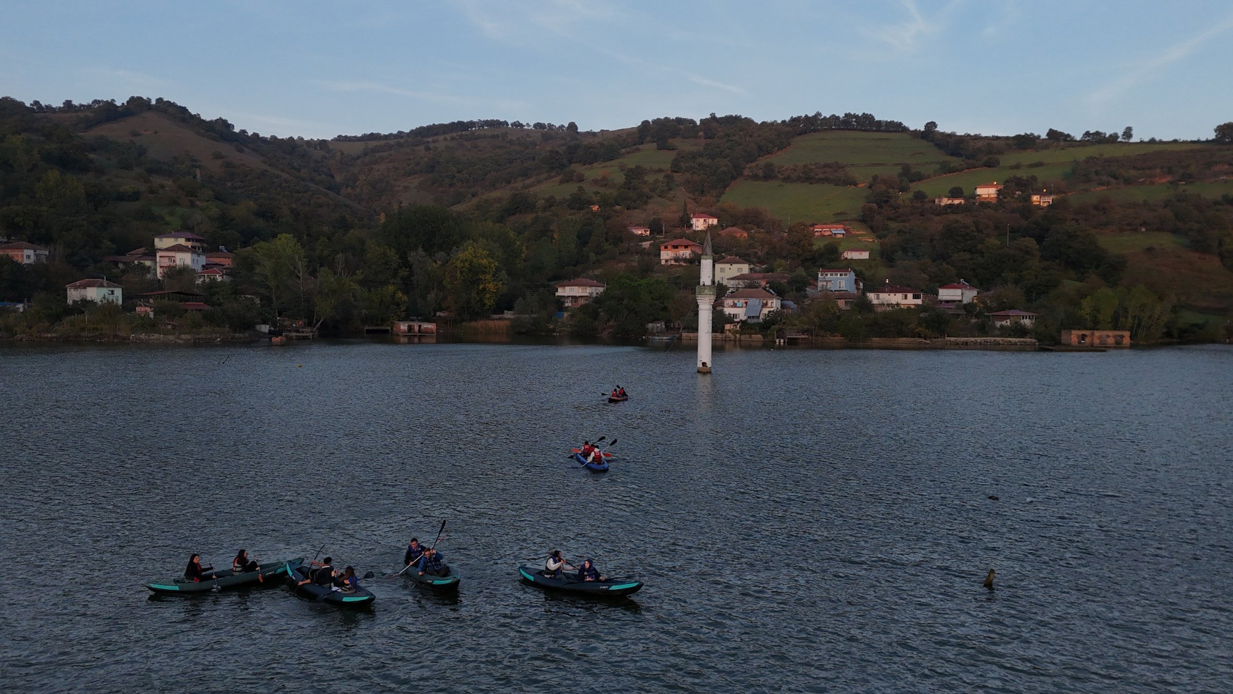 People paddle canoes past the Sunken Minaret on the Kızılırmak River, Bafra, Samsun, Türkiye, Oct. 26, 2026. (AA Photo)