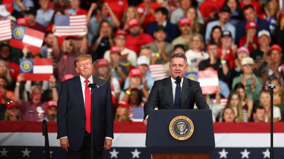 Gernot Dollner, CEO of Audi AG, speaks next to U.S. President Donald Trump during a rally at Guardian Centers, Perry, Georgia, U.S., Oct. 24, 2026. (Reuters Photo)