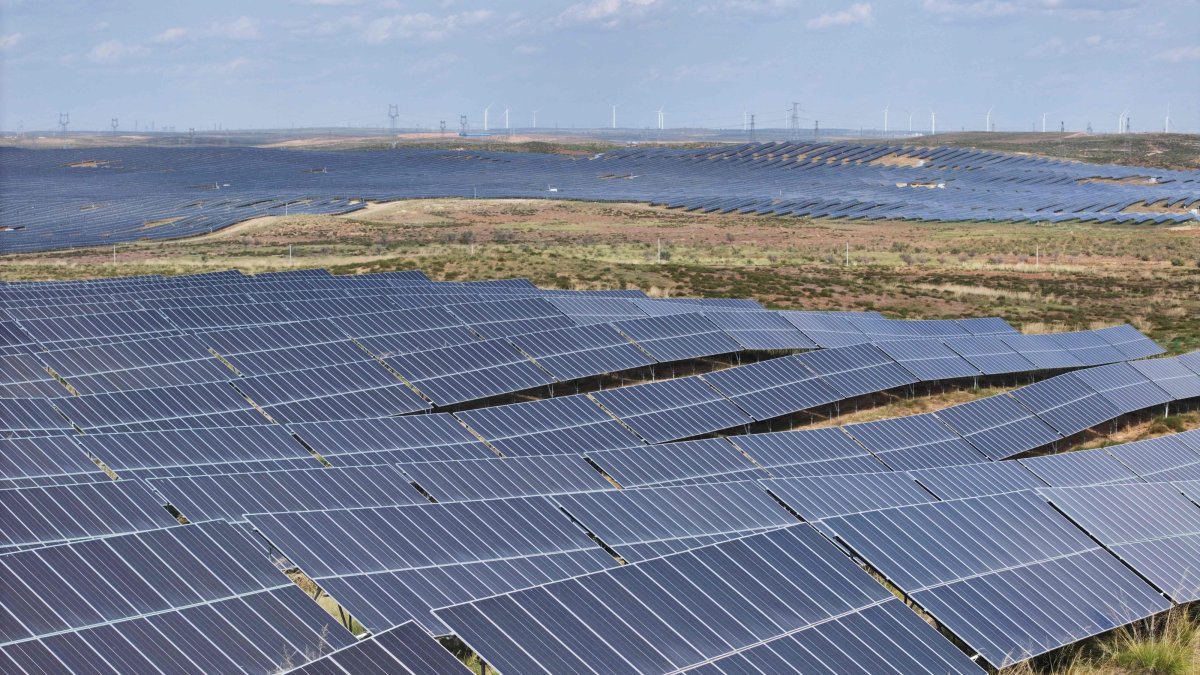 Wind turbines are seen behind solar panels at the Ningdong Energy and Chemical Base in Yinchuan in the northern Ningxia region, China, Sept. 28, 2026. (AFP Photo)