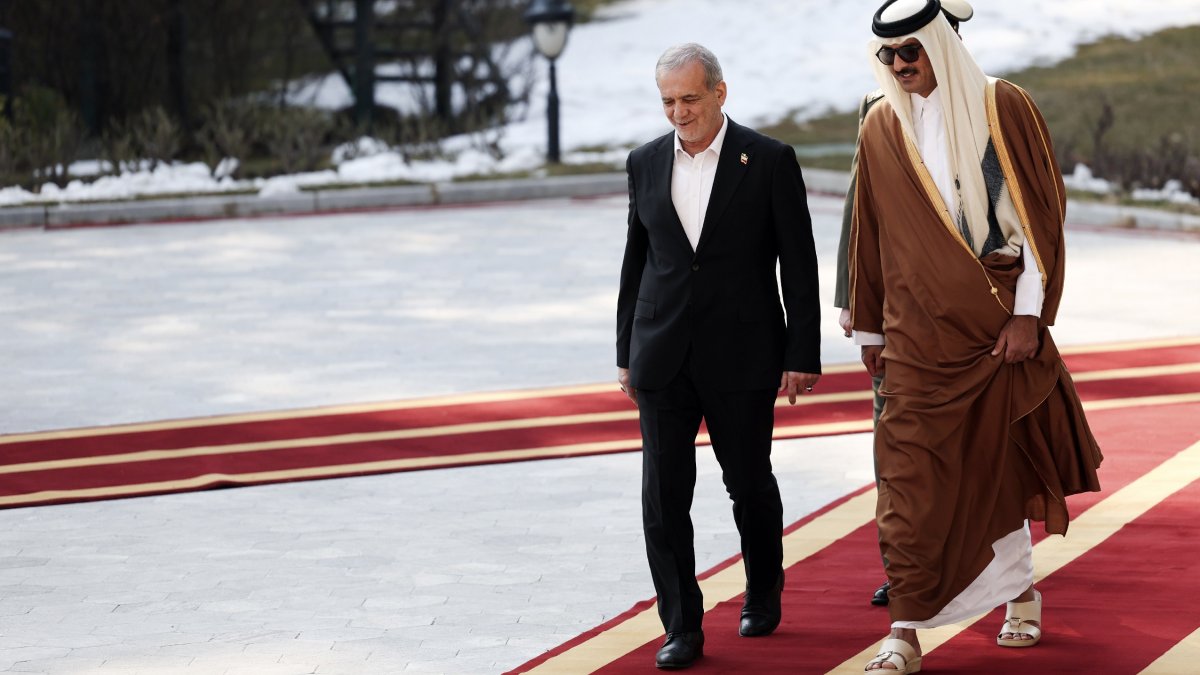 Qatar's Emir Sheikh Tamim bin Hamad Al Thani (R) is welcomed by President Masoud Pezeshkian during an official welcoming ceremony at the Saadabad Palace in Tehran, Iran, Feb. 19, 2025. (AP Photo)