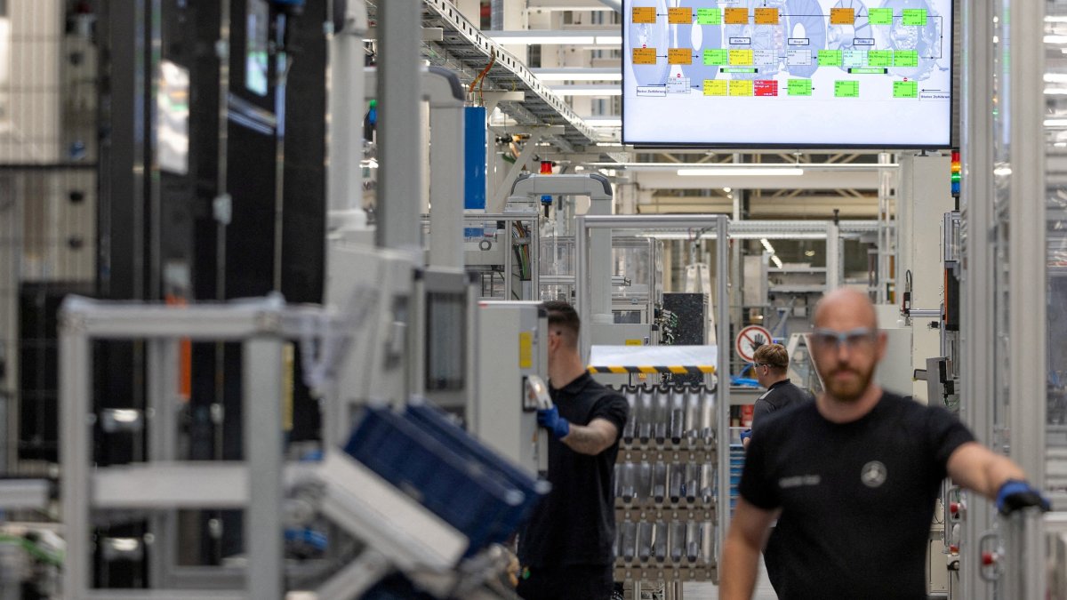 A worker assembles axial-flux motors for electric vehicles on an assembly line at the Mercedes-Benz engine factory, Berlin, Germany, June 9, 2026. (Reuters Photo)