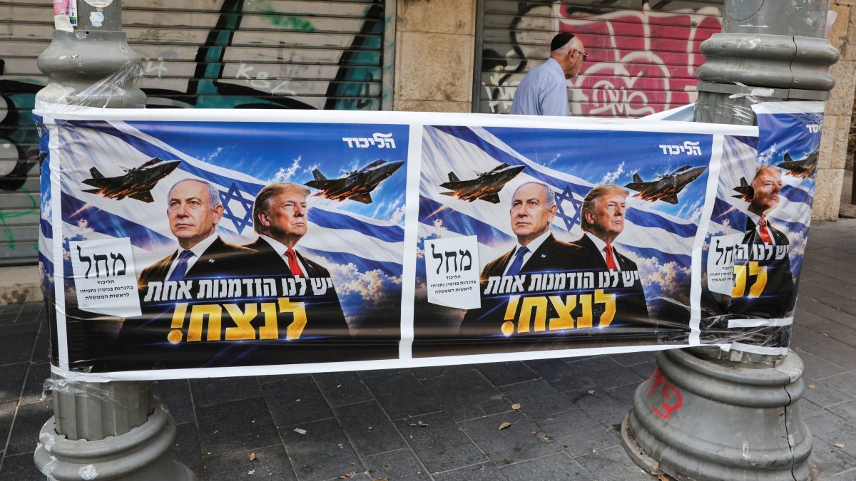 A man walks past a poster of Israeli Prime Minister and Likud party leader Benjamin Netanyahu and U.S. President Donald Trump during the country's national elections, west Jerusalem, Israel, Oct. 27, 2026. (Reuters Photo)
