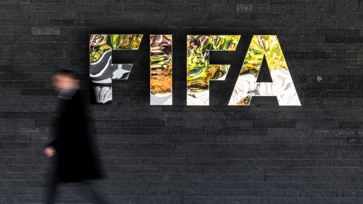 A man walks past a FIFA sign at the headquarters during the FIFA council meeting, Zurich, Switzerland, Oct. 15, 2026. (AP Photo)
