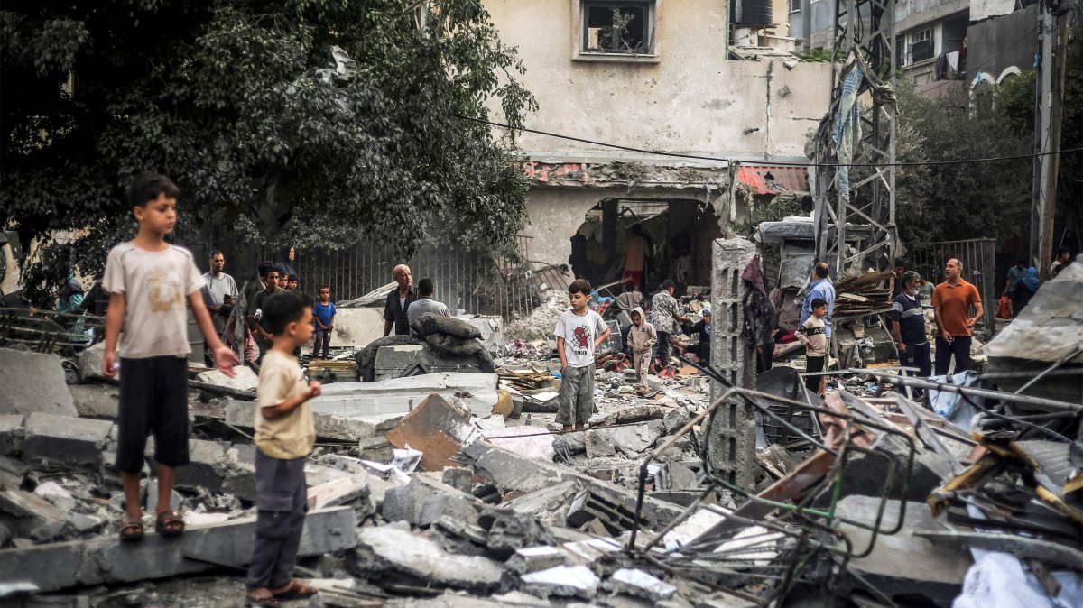 Children stand by the rubble of a destroyed building following an Israeli airstrike in Nuseirat in the central Gaza Strip, Oct. 23, 2026. (AFP Photo)