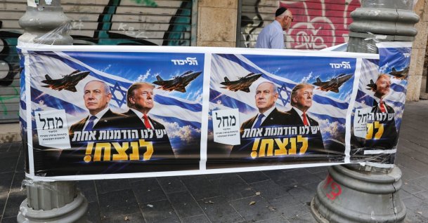 A man walks past a poster of Israeli Prime Minister and Likud party leader Benjamin Netanyahu and U.S. President Donald Trump during the country's national elections, west Jerusalem, Israel, Oct. 27, 2026. (Reuters Photo)