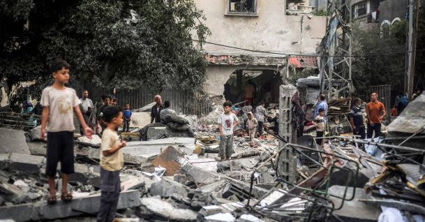 Children stand by the rubble of a destroyed building following an Israeli airstrike in Nuseirat in the central Gaza Strip, Oct. 23, 2026. (AFP Photo)