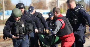 A handout photo released by the press service of the State Emergency Service (SES) of Ukraine shows Ukrainian rescuers evacuating an injured person at the site of a Russian drone strike on a platform at the railway station, Dnipro, Ukraine, Oct. 29, 2026. (IHA Photo)