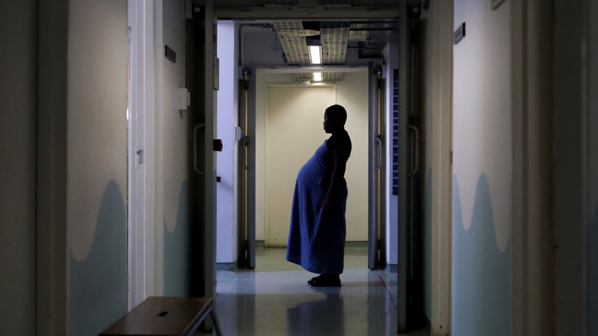 A pregnant woman stands in a corridor after a check-up appointment at Rahima Moosa Mother and Child Hospital, Johannesburg, South Africa, Aug. 5, 2026. (Reuters Photo)